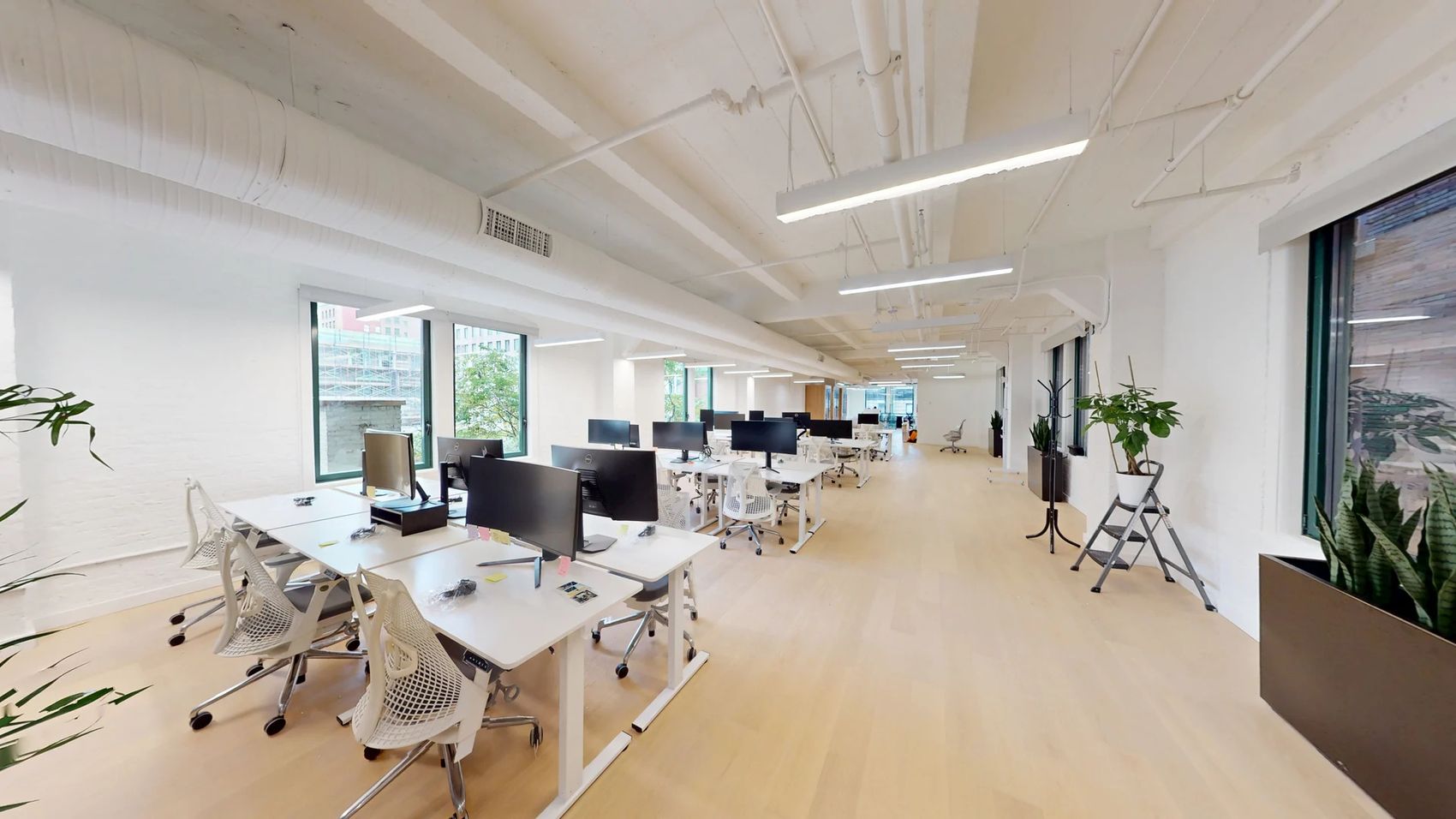 Open floor with exposed ceilings and engineered wood